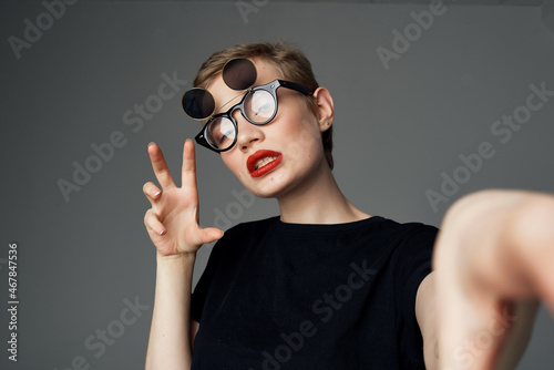 beautiful woman with double glasses fashion dark backgroun