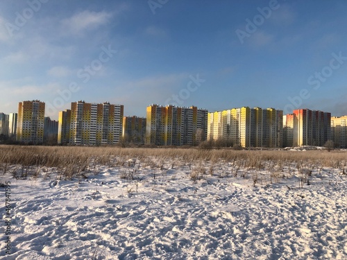 Construction of multi-storey residential buildings in the big city. Winter city landscape
