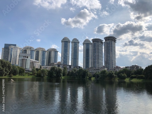 Condo luxury building in twilight near lake. Building condo and light in room evening.