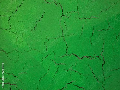 Cracks on a green background. The green texture of cracked wood. © andreysha74