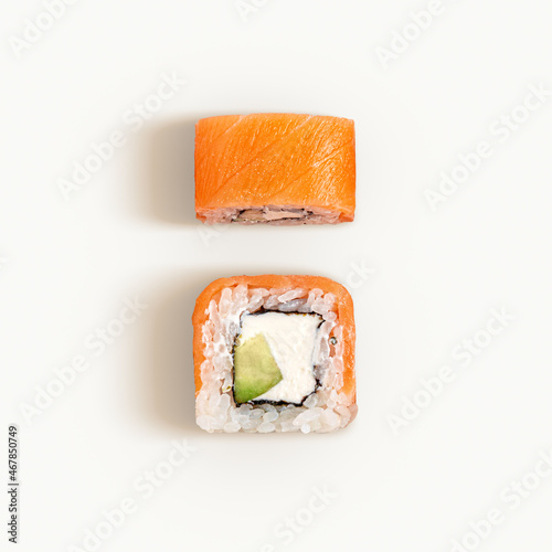Flat lay of two Philadelphia rolls isolated on white. Top view of sushi with salmon and cream cheese