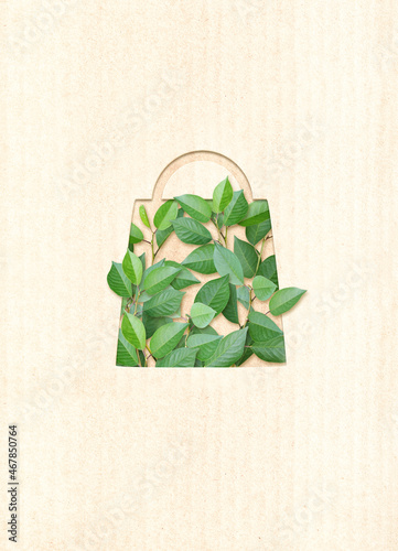 Responsible consumption. Green leaves and shopping bag in paper cut style