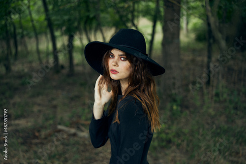 woman witch in black hat in the forest posing fantasy © VICHIZH