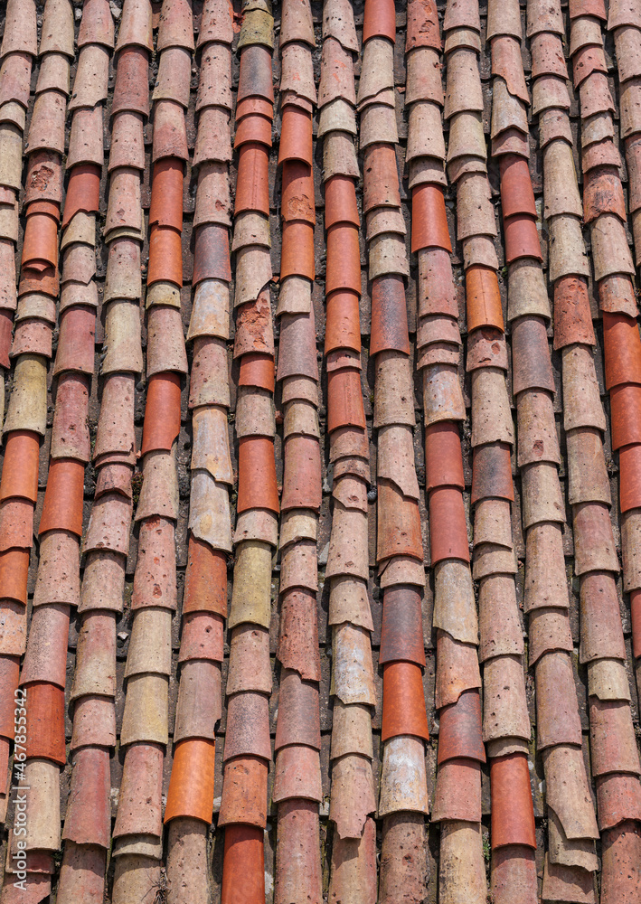 Vertical close-up of old weathered red and orange roof tiles. Vertical close-up of old weathered red and orange roof tiles.