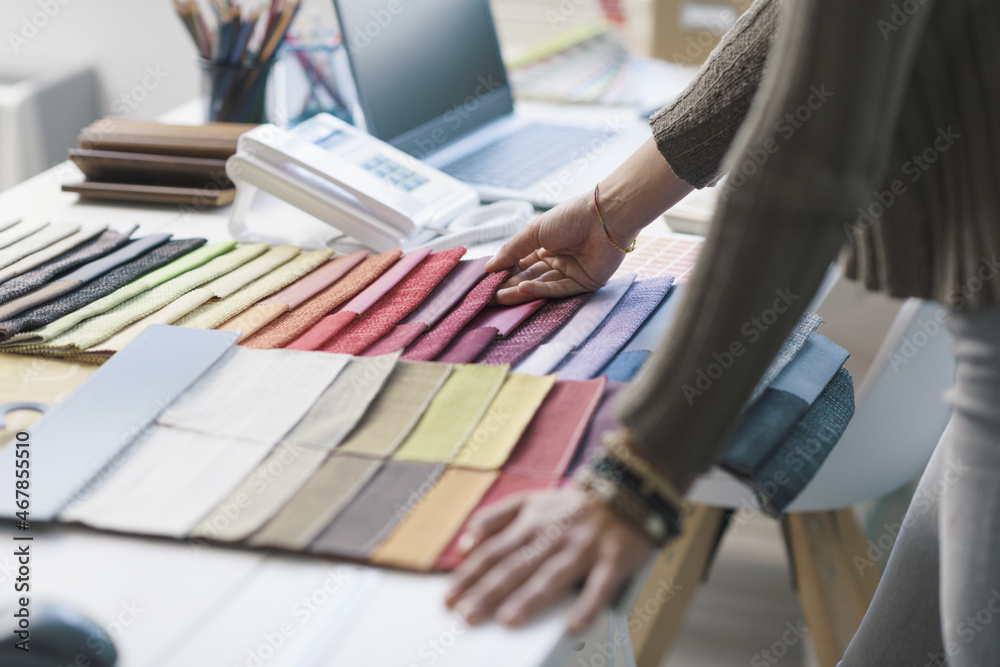 Professional decorator choosing fabric swatches Professional decorator choosing fabric swatches