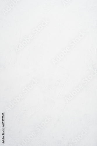 Background image of white uneven concrete surface. Top view, copy space. Vertical