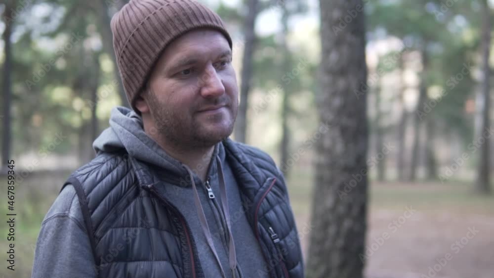 Close-up, Portrait of man standing in forest. Traveling Concept People in Nature. One relaxed tourist looking to the forest On the Background of Autumn Landscape. Close-up, Portrait of man standing in forest. Traveling Concept People in Nature. One relaxed tourist looking to the forest On the Background of Autumn Landscape.