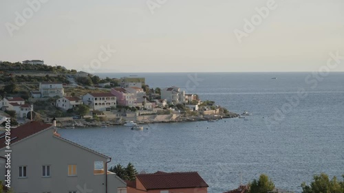 Big cruise ship passing coast town, static. photo