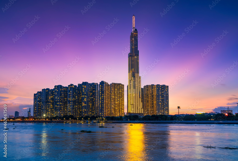 Obraz premium Riverside urban area at sunset sky after a period of social distancing because of the pandemic has revived in Ho Chi Minh City, Vietnam