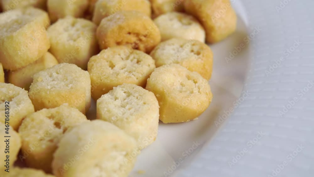 Round baked rough crispy croutons on a white plate. Bread rusks. Macro. Dolly shot Round baked rough crispy croutons on a white plate. Bread rusks. Macro. Dolly shot