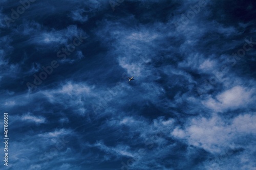 Blue sky with clouds and an aeroplane.