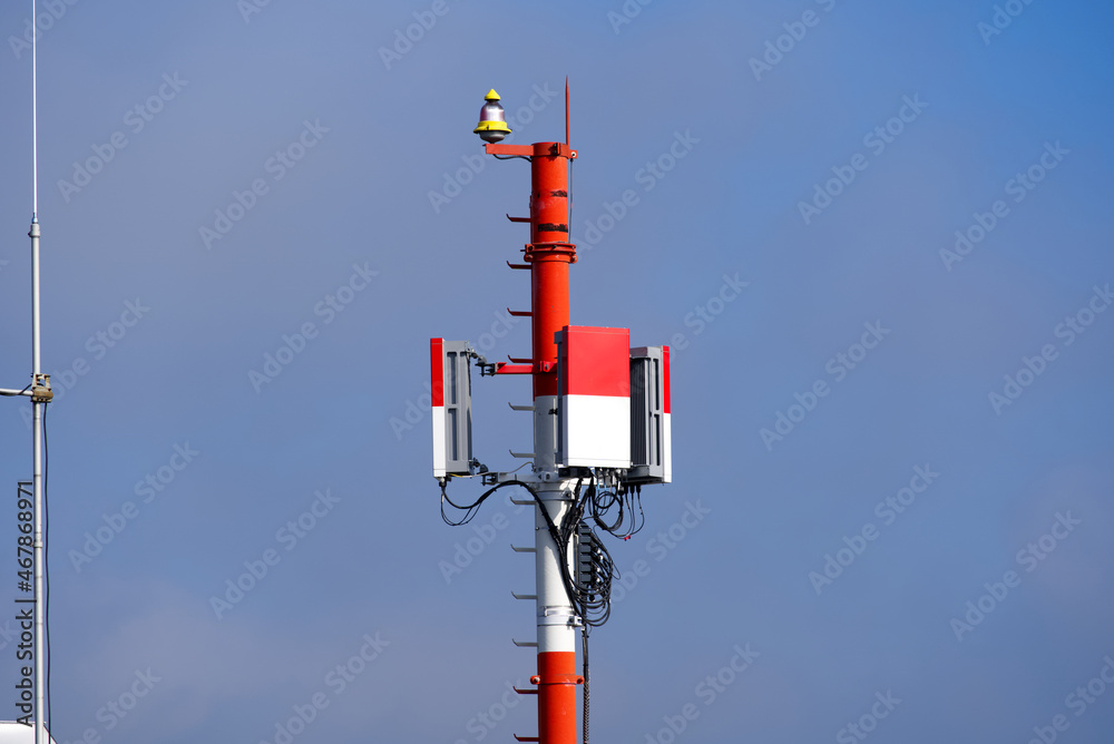 Antennas painted red and white at Zürich airport on a cloudy autumn day. Photo taken October 24th, 2021, Zurich, Switzerland.
