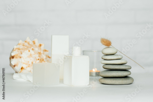 A composition of items for a spa salon. Beauty treatments and massages. Stones representing the balance of feng shui. Close-up, copy space, white background.