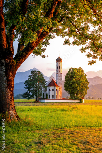 Germany, Bavaria, Schwangau, Meadow in front of Pilgrimage Church of Saint Coloman at dusk photo