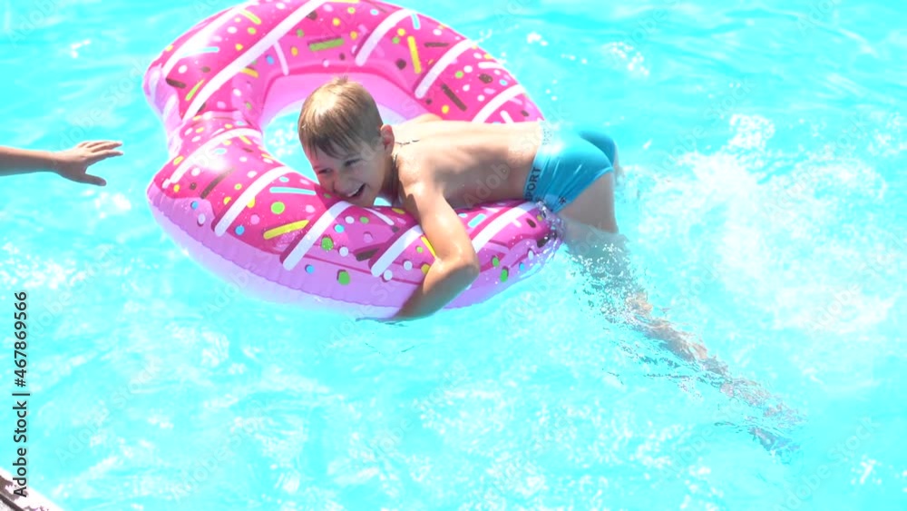 Kids having fun playing in swimming pool on summer vacation Kids having fun playing in swimming pool on summer vacation
