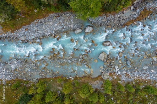 Drone view of Ova da Morteratsch river flowing through Val Morteratsch photo