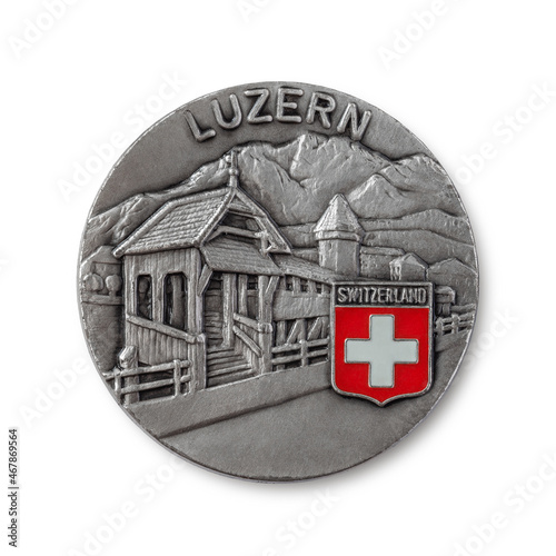Souvenir magnet from Switzerland. The city of Lucerne. Popular souvenirs and tourist collectibles. Close-up photo on a light background.