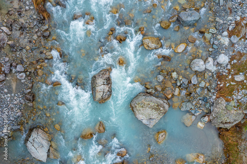 Drone view of Ova da Morteratsch river flowing between rocks