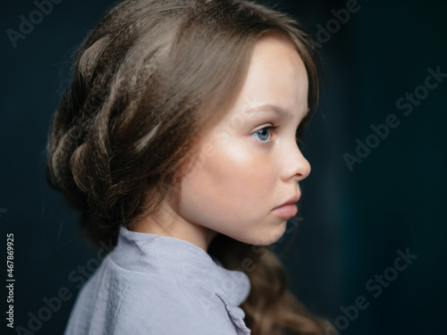 little girl fashion hairstyle posing dark background studio