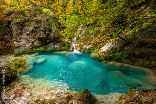Forest turquoise blue lake with white marble stones and waterfalls in Nature Park Urbasa-Andia  Urederra.