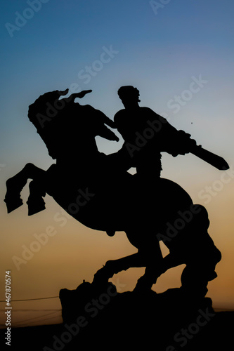 Silhouette of man on horse statue. Man riding horse statue. Monument of man with war horse. Monument of Sasuntsi Davit in Yerevan, Armenia photo