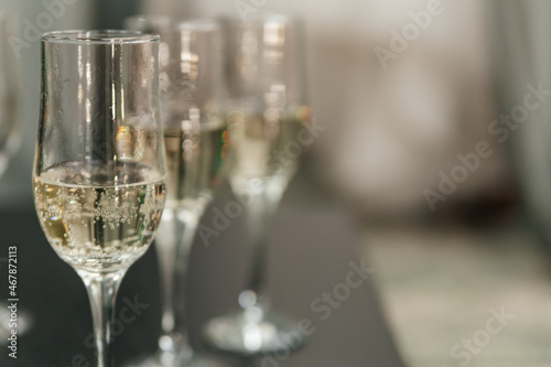 Close-up of champagne glasses in a row on the table. Copy space.