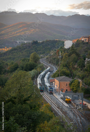 View from old part of city to railway station and two electric trains at platform in Roviano, Italy photo