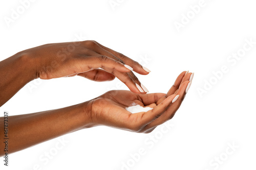 Close up of black woman hands with moisturizer cream photo
