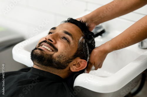 Man getting a hair wash at a barber shop