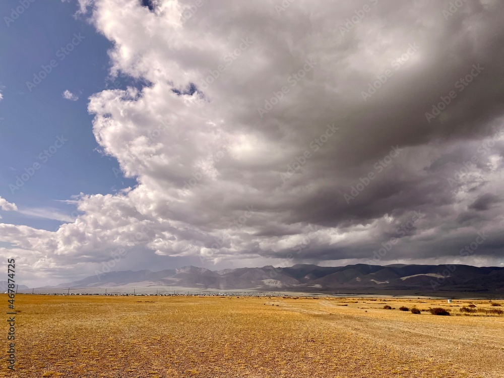 Steppe against the background of the Altai mountains on a beautiful cloudy day. Steppe against the background of the Altai mountains on a beautiful cloudy day.