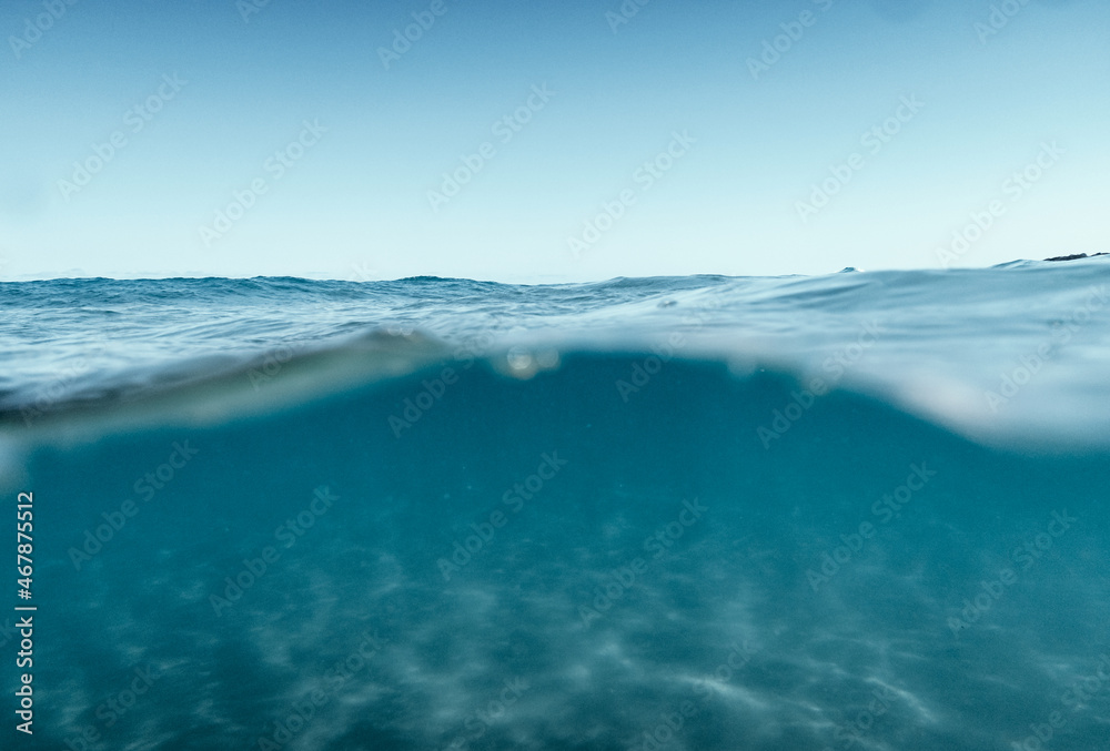 Split View Half Over and Under Ocean Surface whit Clear Sky. Background Concept