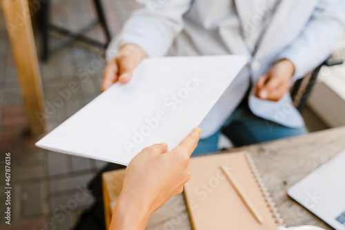 Young man and woman working with papers during business meeting © Drobot Dean