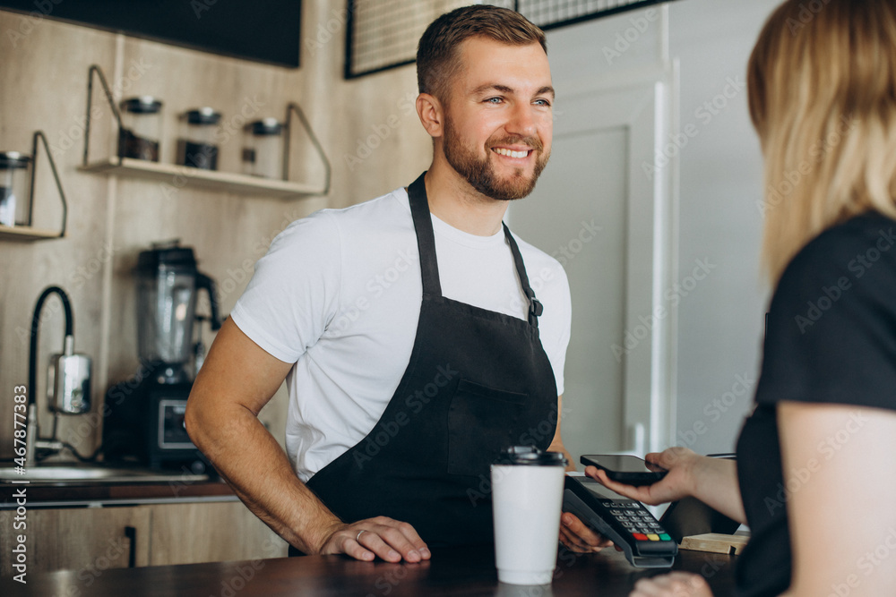Customer paying with card in a coffee house Customer paying with card in a coffee house