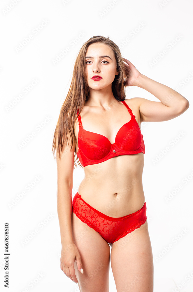 Fototapeta premium Beautiful, sexy, elegant blonde woman in red lingerie on a white background