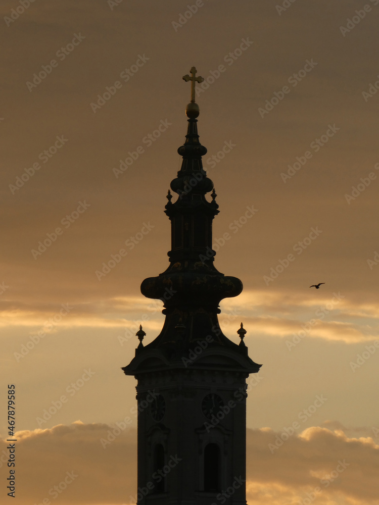 The church tower with cross in the morning, with flying bird and  sky background