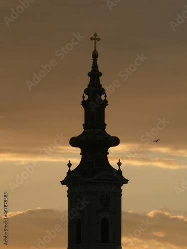The church tower with cross in the morning  with flying bird and  sky background