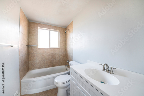 Interior of a bathroom with window on top of a bathtub