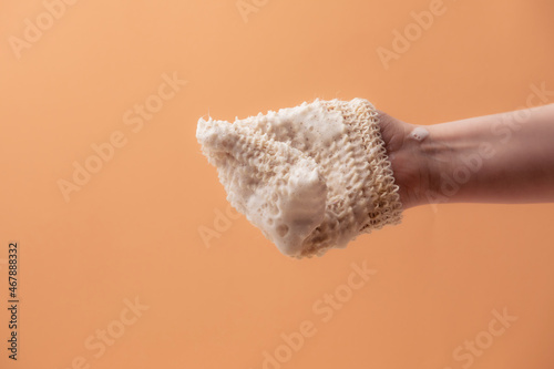 Natural biodegradable washcloth in the female hands photo