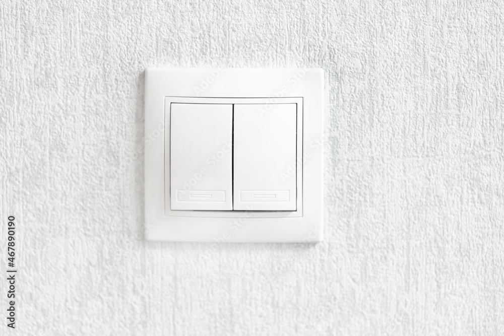 White double light switch on the wall White double light switch on the wall