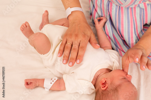 Mom teaches her newborn baby sucking reflex photo