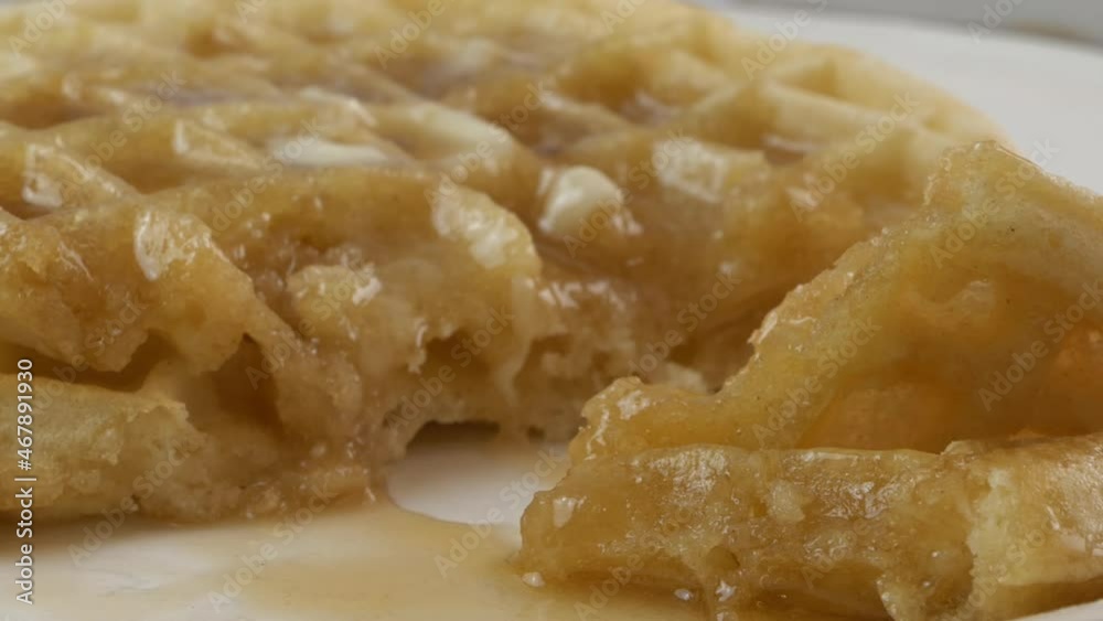 Eating a forkful of a waffle with butter and syrup close up Eating a forkful of a waffle with butter and syrup close up