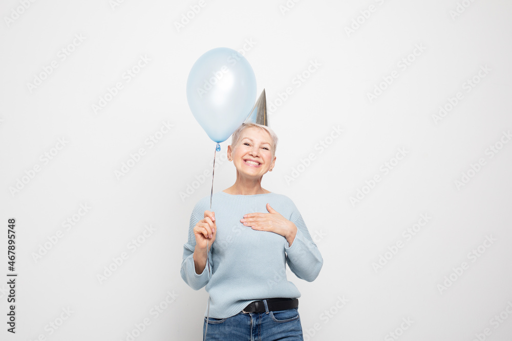 Portrait of attractive lovely overjoyed cheerful cheery gray-haired lady holding blue balloon having fun Portrait of attractive lovely overjoyed cheerful cheery gray-haired lady holding blue balloon having fun