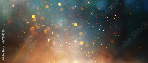 background of abstract glitter lights. gold  blue and black. de focused