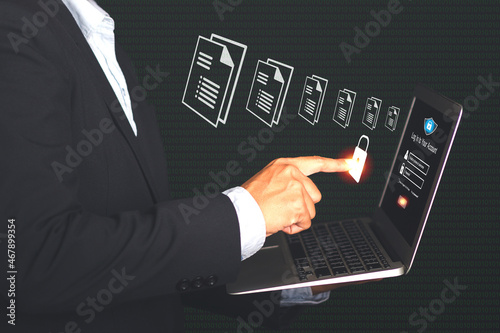 Document management system concept. Businessman using finger touch security icon on the virtual screen for unlocking to documentation database and process to efficiently manage files information