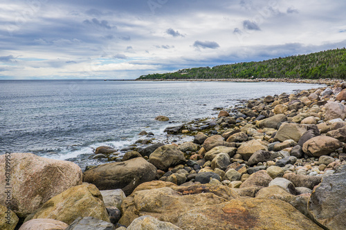 View on the rocky shore of St Lawrence river near Baie Comeau, in Cote Nord region of Quebec, Canada photo