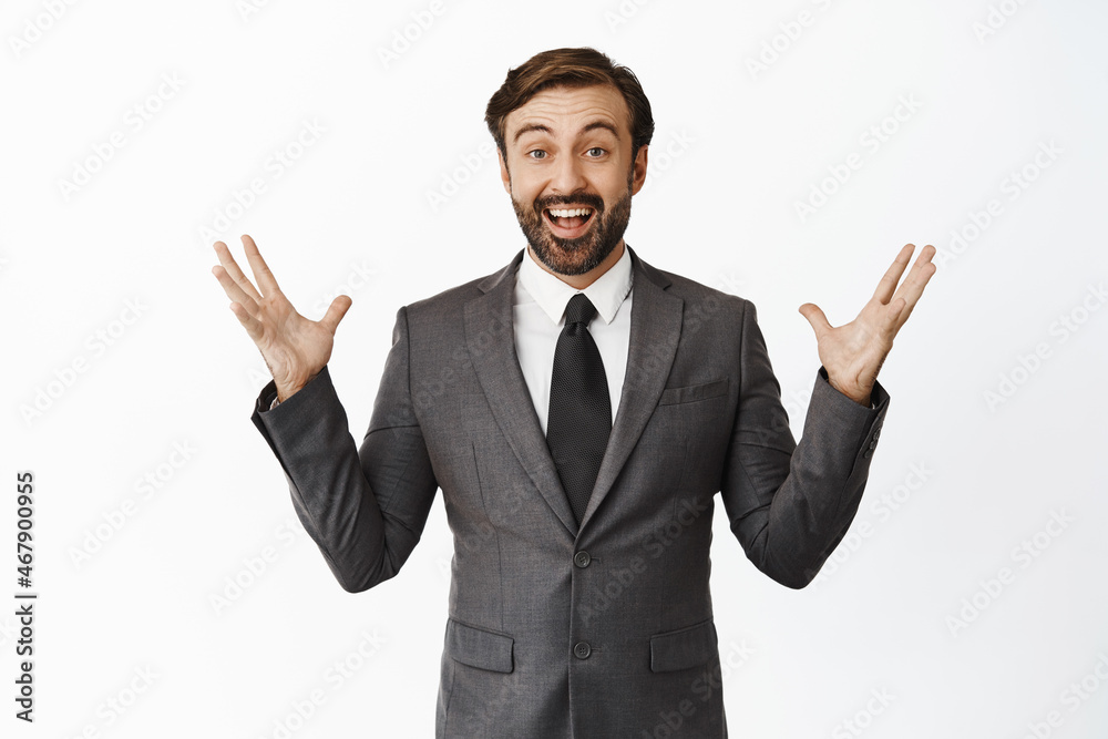 Portrait of enthusiastic salesman celebrating, looking happy and amazed, cheering from great news, achieve goal or win, triumphing, standing over white background Portrait of enthusiastic salesman celebrating, looking happy and amazed, cheering from great news, achieve goal or win, triumphing, standing over white background
