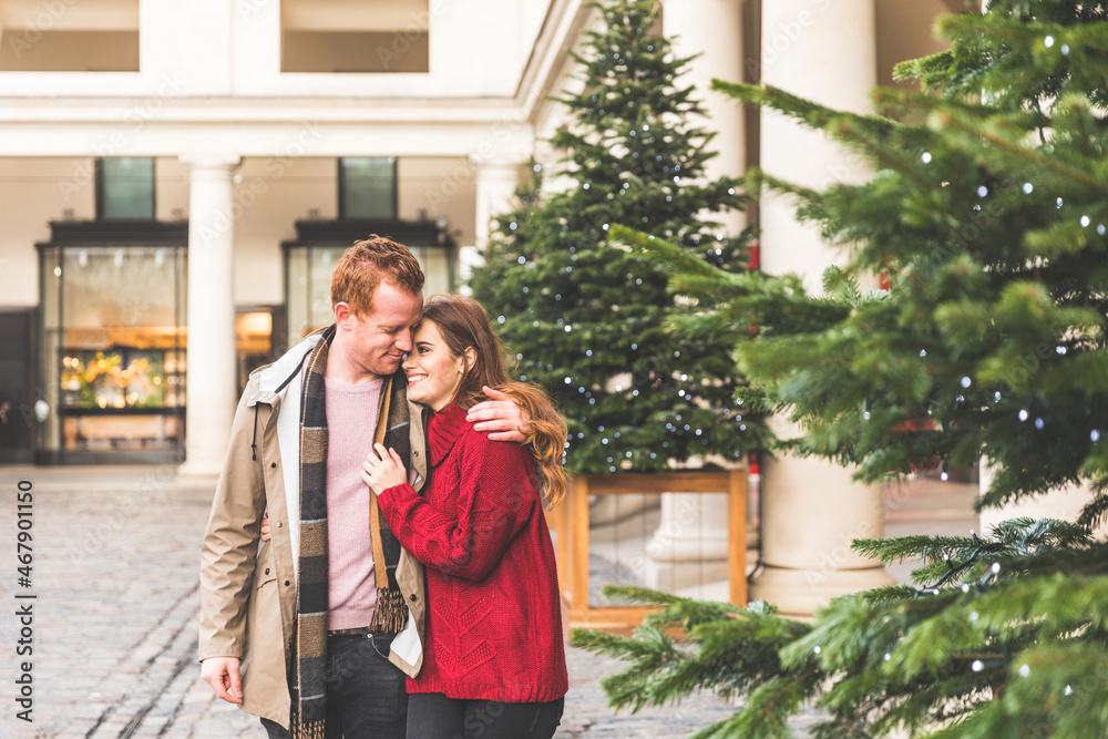Couple hugging and walking in London at Christmas time