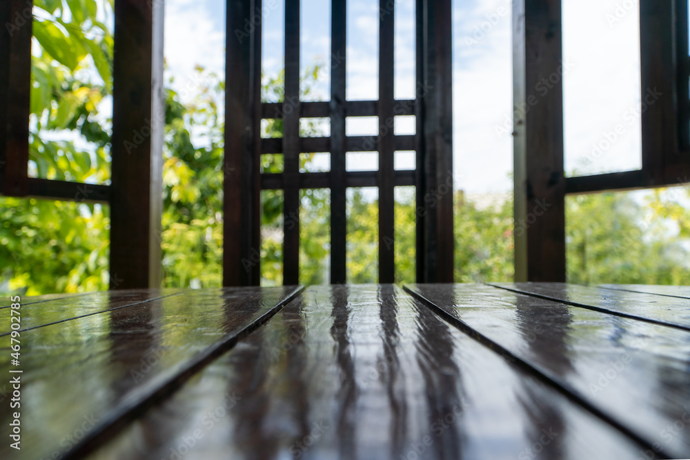 Fototapeta premium Empty wooden table and blurred view of someone. Background for your product.