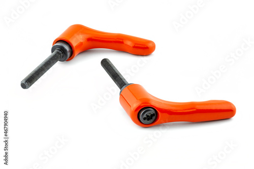 Macro photo of two orange clamp levers with black thread, isolated on a white background.
