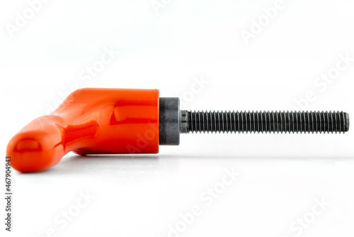 Macro photo of an orange clamping lever with black thread, isolated on a white background.